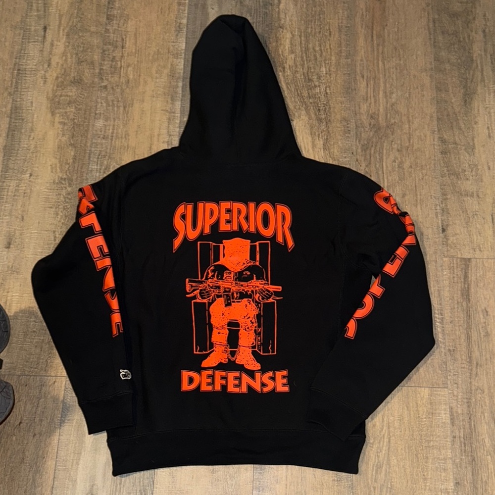 Black and Orange Sweatshirt with Superior Defense Graphic